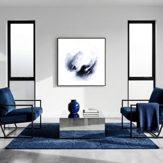 Modern living room with blue chairs, a reflective coffee table, and semi-abstract art by Neil McBride on the wall.